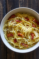 Pasta spaghetti carbonara on a wooden background. Italian cuisine. Recipe. Rustic style.