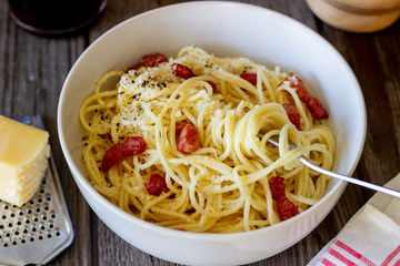 Pasta spaghetti carbonara on a wooden background. Italian cuisine. Recipe. Rustic style. Wine.