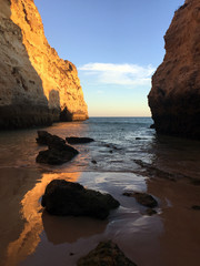 Fototapeta na wymiar sea ​ between rocks at sunset