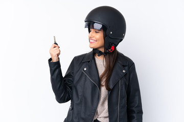 Young brunette woman with a motorcycle helmet and holding a key over isolated white background