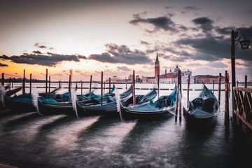 Sunrise in San Marco square with gondole service tourist people, Venice. Italy 
