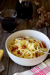Pasta spaghetti carbonara on a wooden background. Italian cuisine. Recipe. Rustic style. Wine.