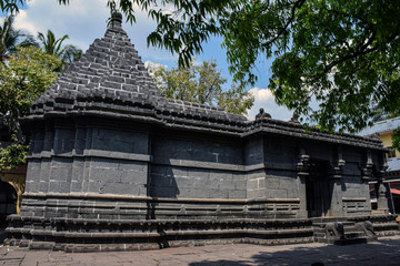 Naklejka premium Side view of ancient shiva temple in indian village