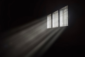 Beams of light through a barred prison cell window - Powered by Adobe