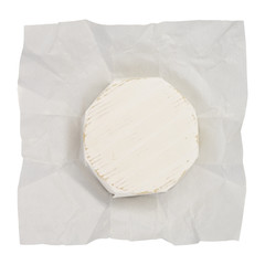 Open paper package of whole head of brie or camambert cheese isolated on white background.