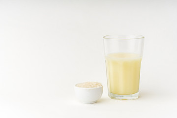 Dairy alternative. Rice milk in a high glass on white background.