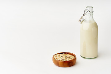 Oat milk in a glass bottle. Dairy alternative. Healthy vegan protein drink