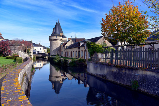 Keep of the fortified gate Saint-Julien on the Huisne river with big reflection at La-Fert&eacute;-Bernard, a commune in the Sarthe department in the Pays de la 	Loire region in north-western France.