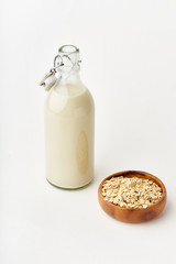 Oat milk in a glass bottle. Dairy alternative. Healthy vegan protein drink