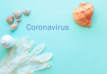 Summer vacation, beach rest and medical protective mask, gloves, antiseptic on mint blue background. Coronavirus covid-19 travel. Flat lay. Copy space. pandemic quarantine self isolation, 2019-nCoV