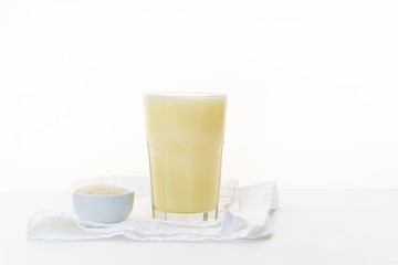 Dairy alternative. Rice milk in a high glass on white background.