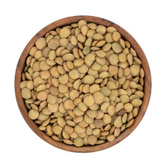 Lentils in wooden bowl isolated on white background with clipping path