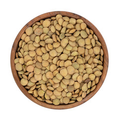 Lentils in wooden bowl isolated on white background with clipping path