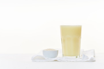 Dairy alternative. Rice milk in a high glass on white background.