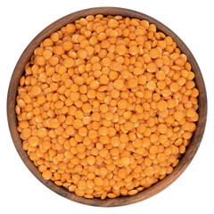 Red lentil in wooden bowl. Isolated on the white background
