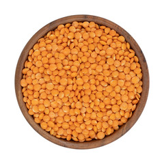 Red lentil in wooden bowl. Isolated on the white background