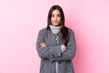 Young brunette woman over isolated pink background feeling upset