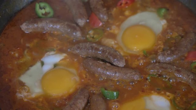 Close up shot of wiener sausages and egg on the grill