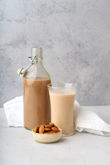 Chocolate almond milk with a bowl of raw almonds. Healthy vegan protein drink. Dairy alternative