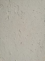 Old crackled white painted concrete wall