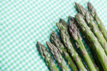 Green asparagus on a checkered tablecloth