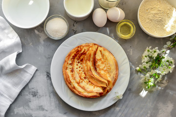 Thin homemade pancakes with berries, pancakes with cherries. Light concrete background. Top view. Tasty sweet breakfast. Traditional English and French crepes. Ingredients. Cooking.