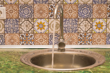 Water from the tap in the sink in the kitchen