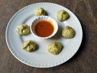 some fresh eatable food put in a plate with red chutney