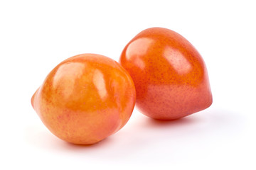 Juicy yellow plums, isolated on white background