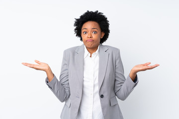 African american business woman over isolated white background having doubts with confuse face...