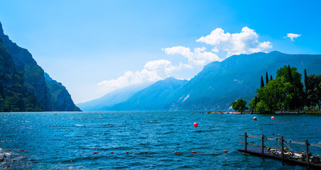 Beautiful nature background. Panorama of the gorgeous Lake Garda surrounded by mountains, Italy.