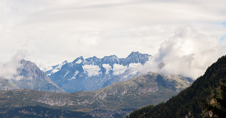 Fototapeta premium The mountains of Switzerland, the summits of the mountains with snow in summer