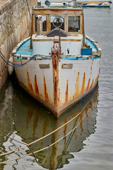 Fototapeta na wymiar Old wooden fishing boat docked in harbour