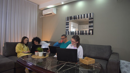 Family smart working and education with video conference. Sitting relaxed in pyjama at home preventing spread of corona covid-19 virus, world pandemia