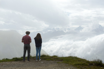 Obraz premium guy with a girl in the clouds, switzerland in the summer