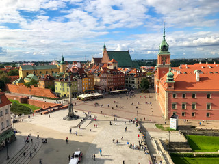 Naklejka na ściany i meble Warsaw, Poland - 21/ 06/ 2019: Beautiful multi-colored houses in the old town in Warsaw. The central streets of the historic center of Warsaw. Castle Square View from the Town Hall.