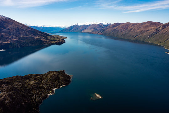 Stunning aerial image of the Wanaka lake with the snowy Mount Aspiring in the background on a sunny winter day, New Zealand © RG41_official