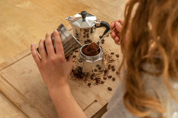 Woman cooks her own coffee espresso in the traditional way