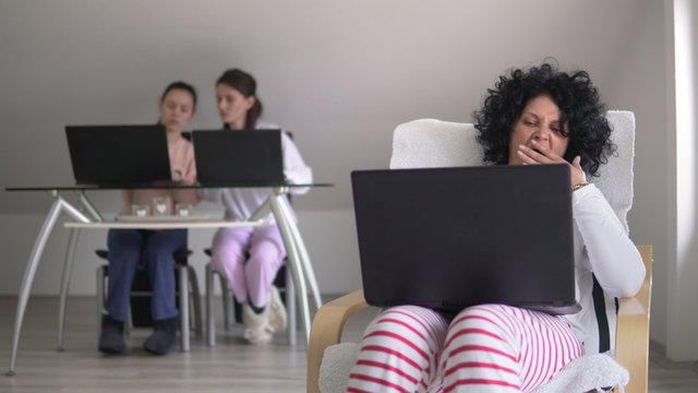 Working from home.in a relaxing environment. distance work and education, family sitting on laptops in pajamas and keep social distancing as prevention from corona covid19 virus spread