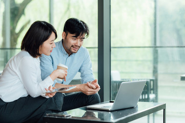 Fototapeta premium Young Asian business man and woman
