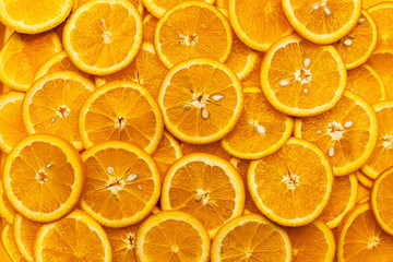 Bright orange background with slices of juicy oranges. Orange in the section. Orange-abstract fruit...