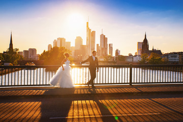 a happy bride and groom in the city at sunset