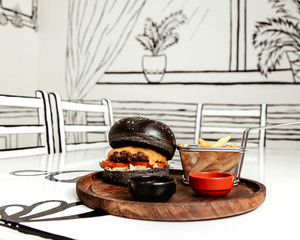 black cheeseburger with side fries