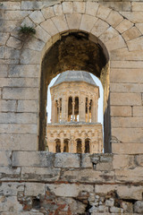 Fototapeta na wymiar SPLIT, CROATIA - 2017 AUGUST 15. Bell tower of the Cathedral of Saint Domnius behind the open stone window in the street of Split.