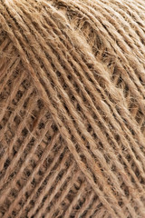 Natural jute ball of twine close-up. Supplies and tools for manual work hobby leisure. Rope in a skein close-up.