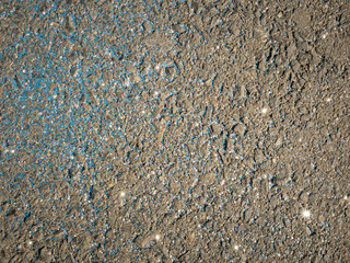 Blue glitter on concrete. Background with shiny texture.