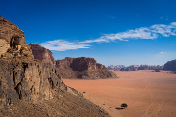 View from Jebel Rum in wadi rum desert, camp from view, Rock mountains in Jordan, lonely tree in the desert