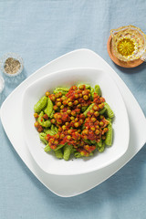 Italian fresh traditional sardinian pasta gnocchi with spinach and green pea tomato sauce. spring...