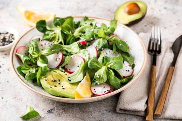 Salad of fresh vegetables and herbs. Appetizer with radish, avocado and mung bean salad. Concept of healthy eating. Vitamins for immunity. Food for vegetarians.