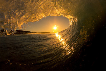 sunset from inside a breaking wave